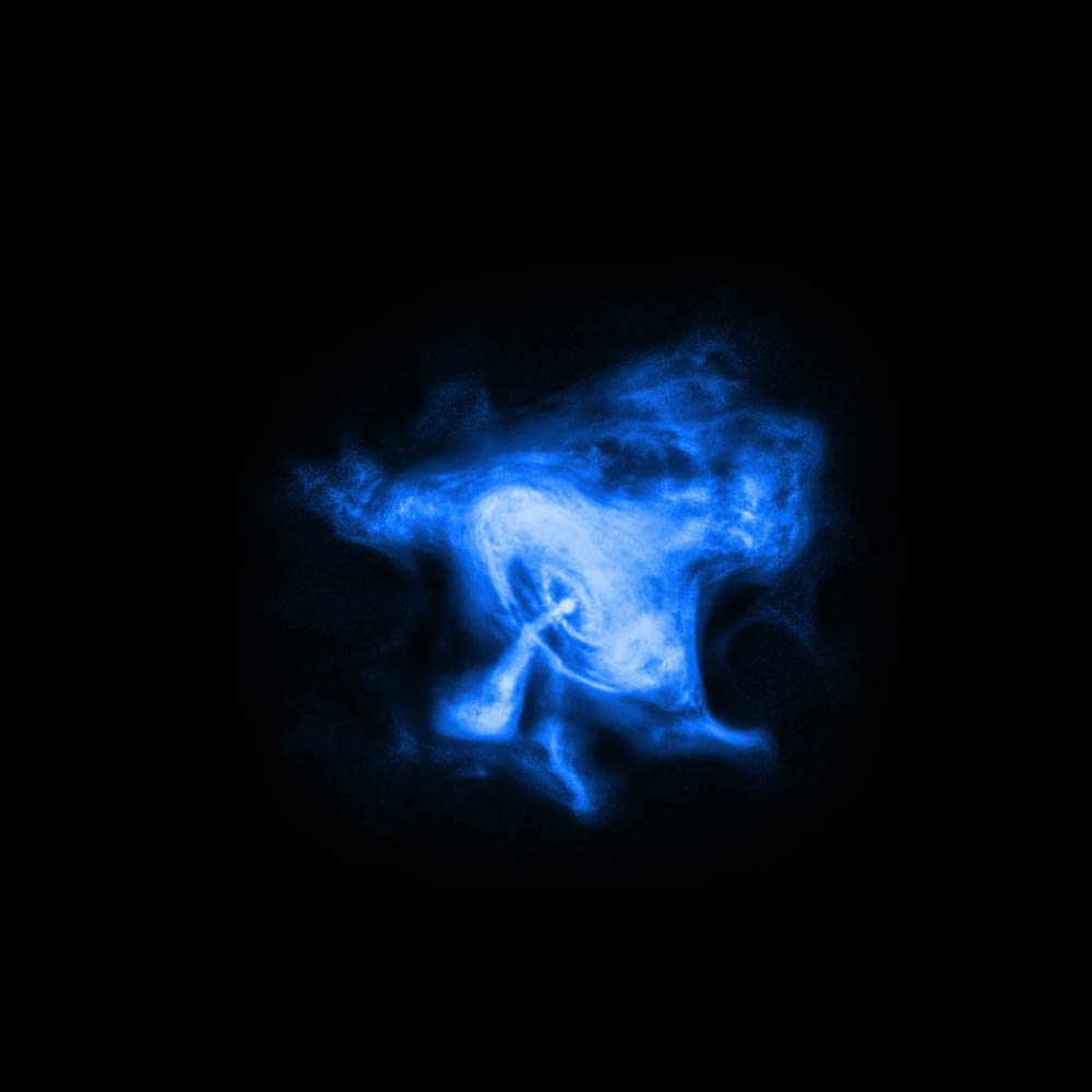 a black background with blue smoke in the middle