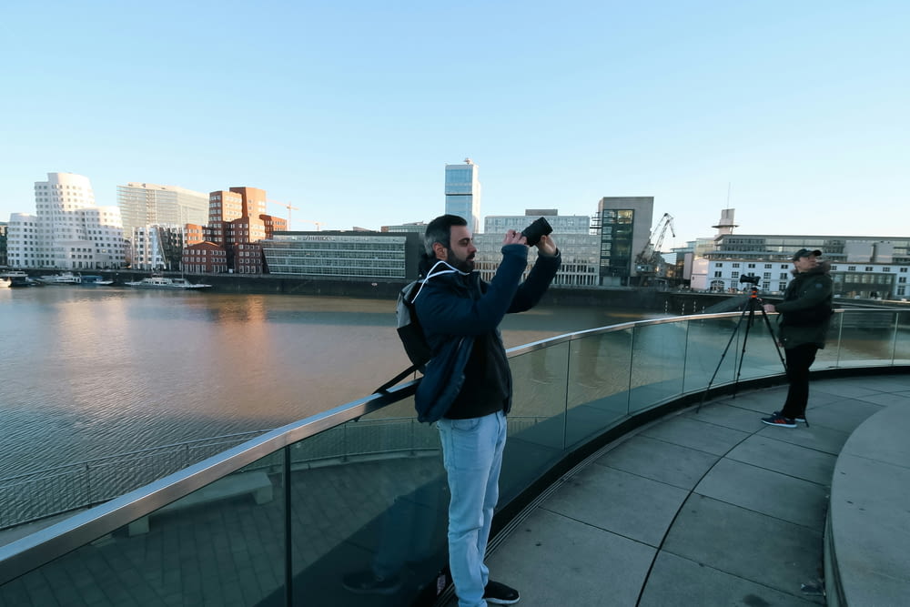 a man taking a picture of himself on a bridge