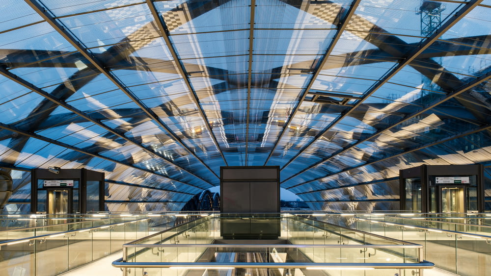 a glass ceiling in a building with a sky background