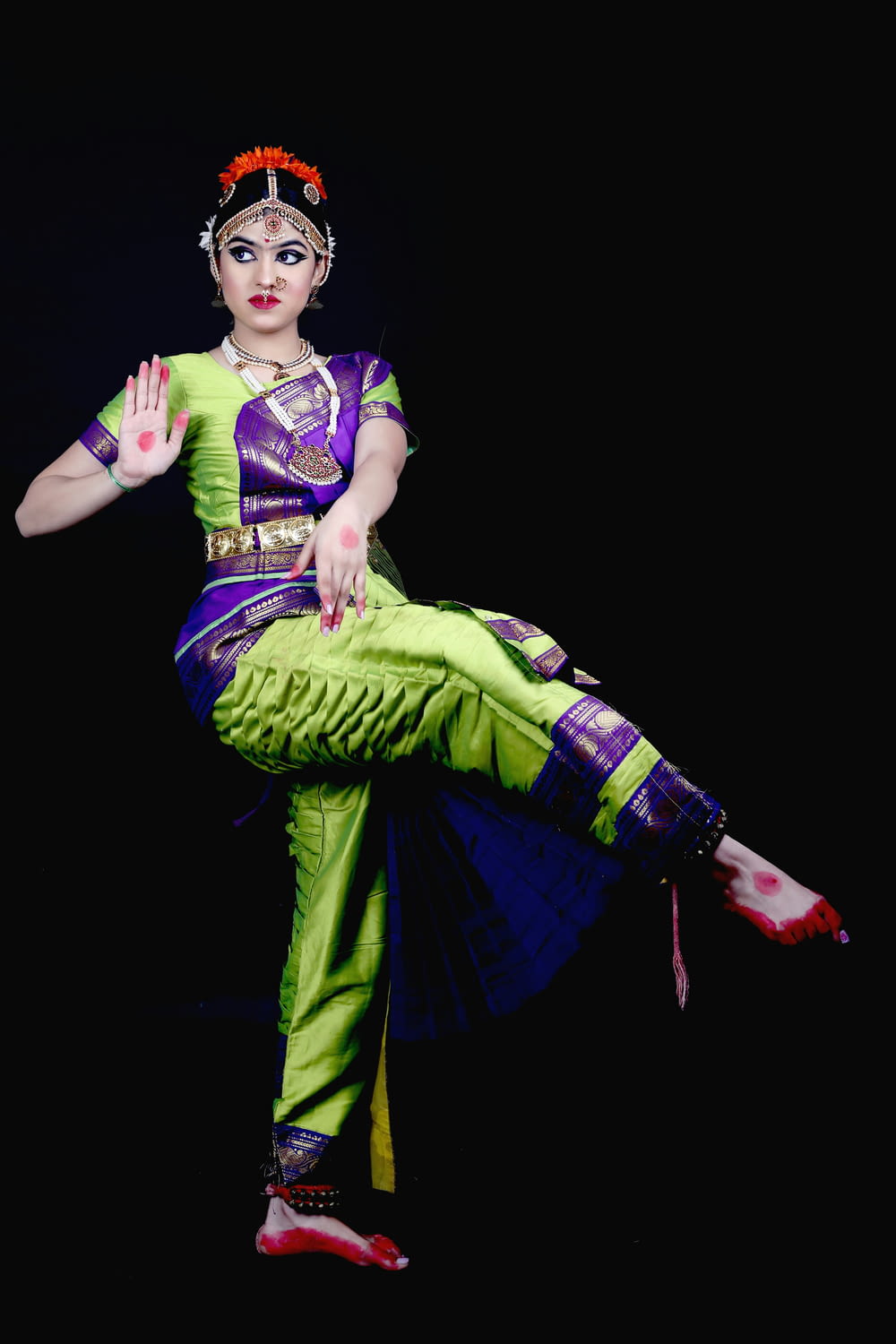 a woman in a green and purple outfit