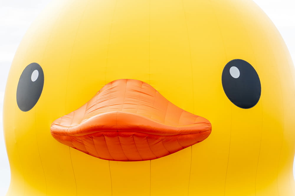 a large yellow rubber ducky floating on top of a body of water