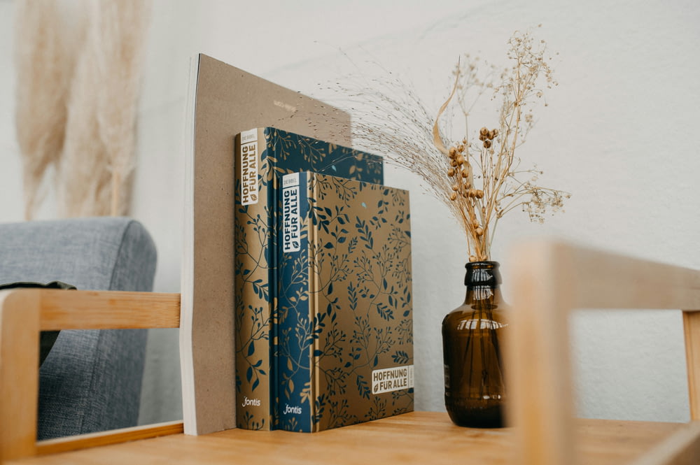 a book and a vase on a table