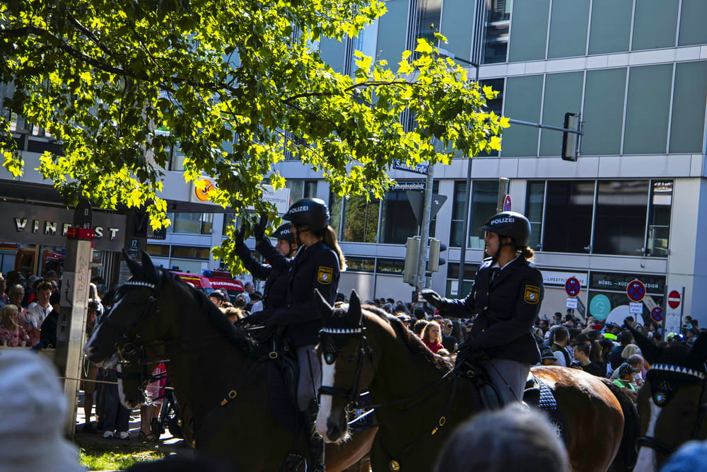 two police officers riding on the backs of horses