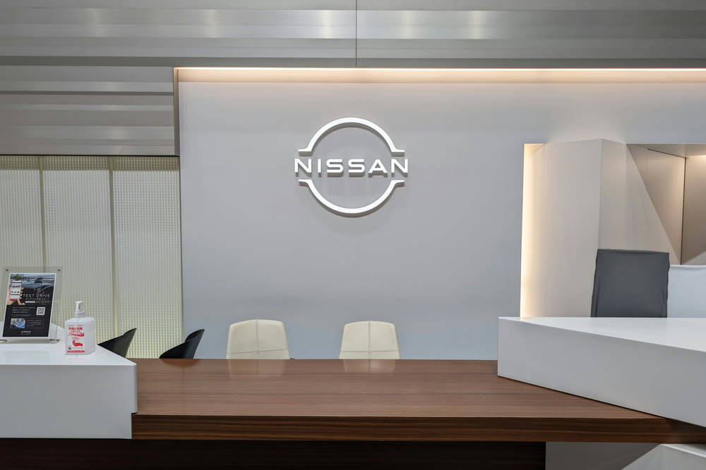 a conference room with a nissan logo on the wall