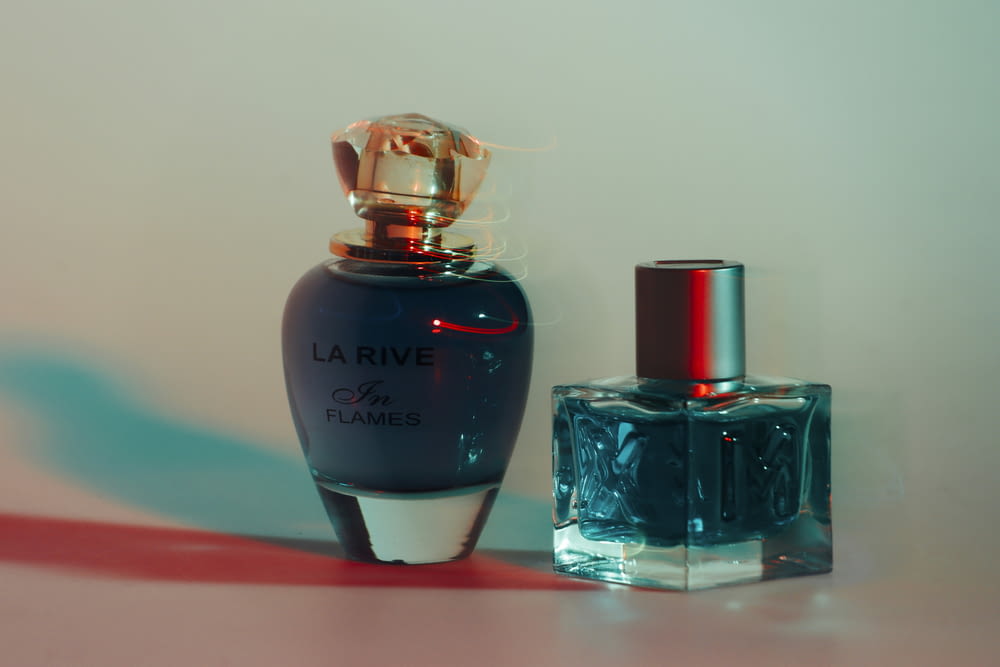 a bottle of perfume next to a bottle of perfume
