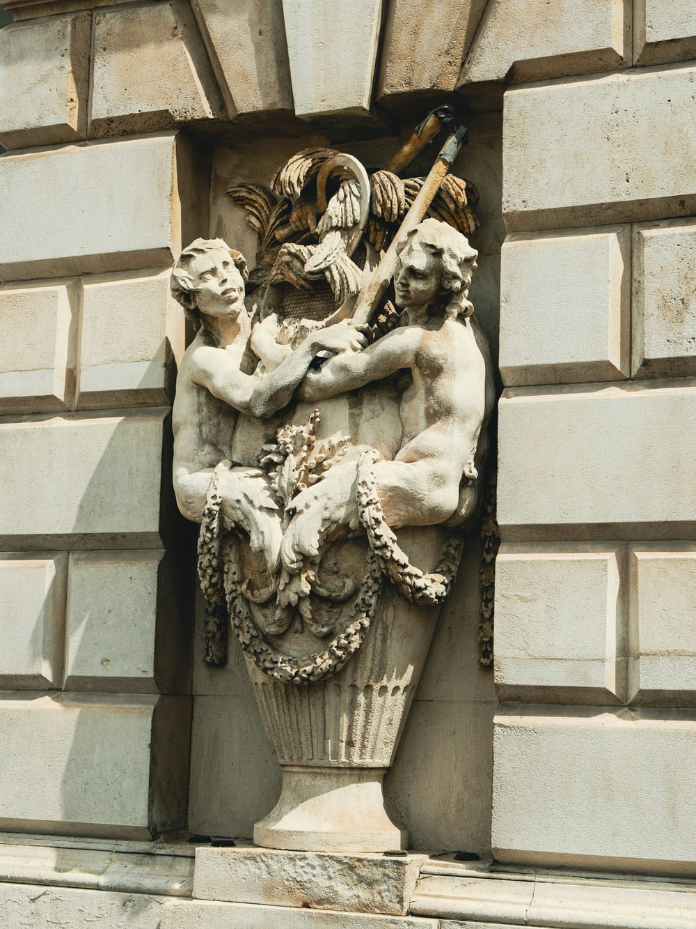 a statue of two men holding a baseball bat