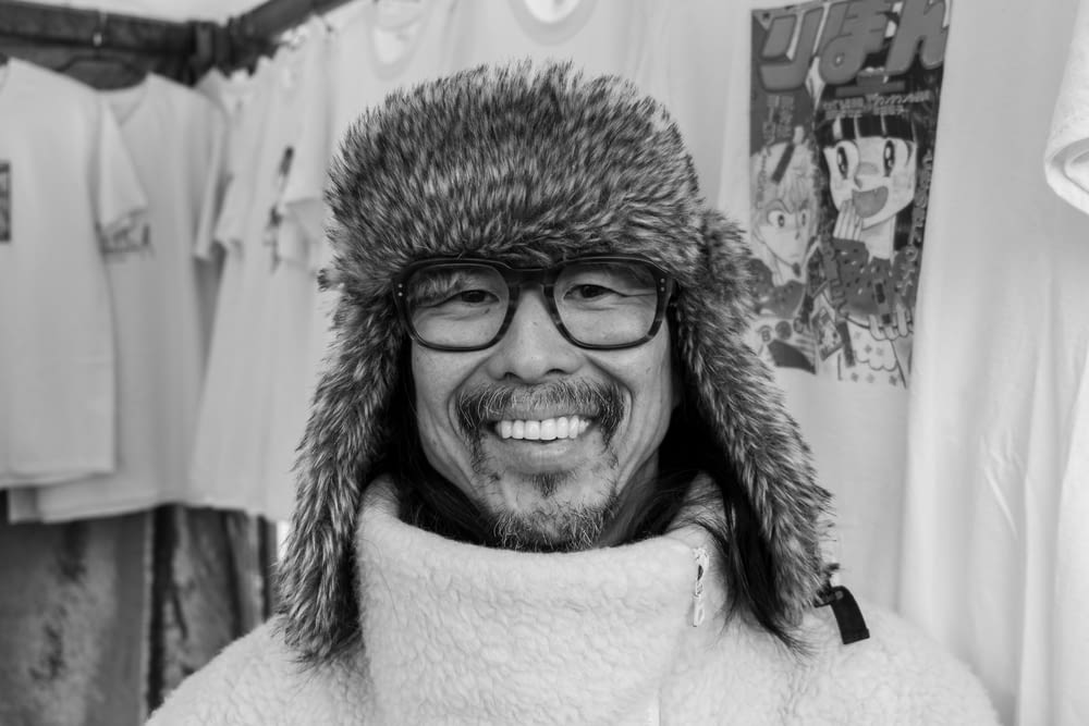 a man wearing a furry hat and glasses