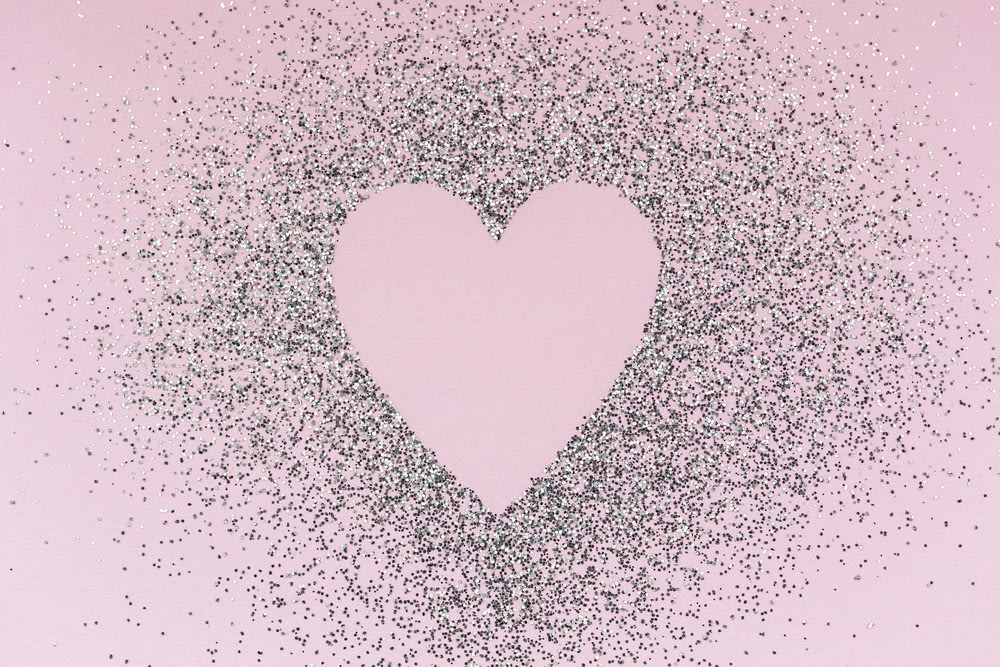 a pink background with a heart shaped frame