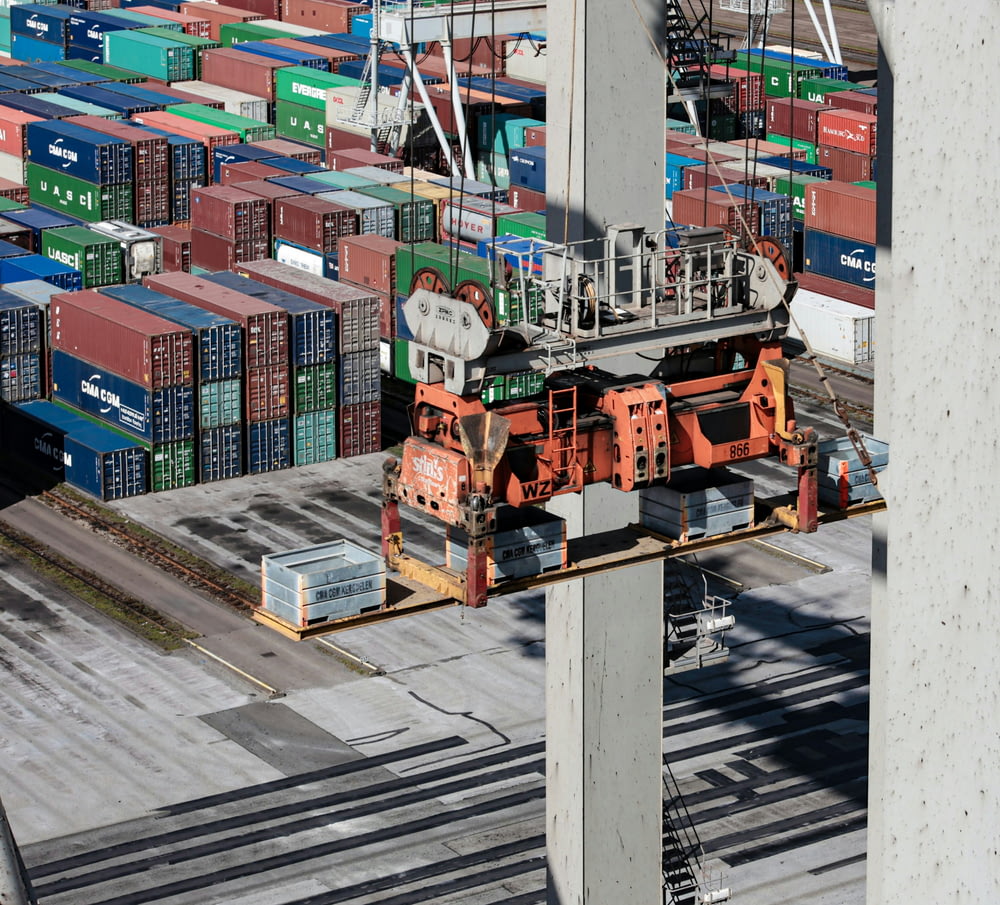 an overhead view of cargo containers and a crane