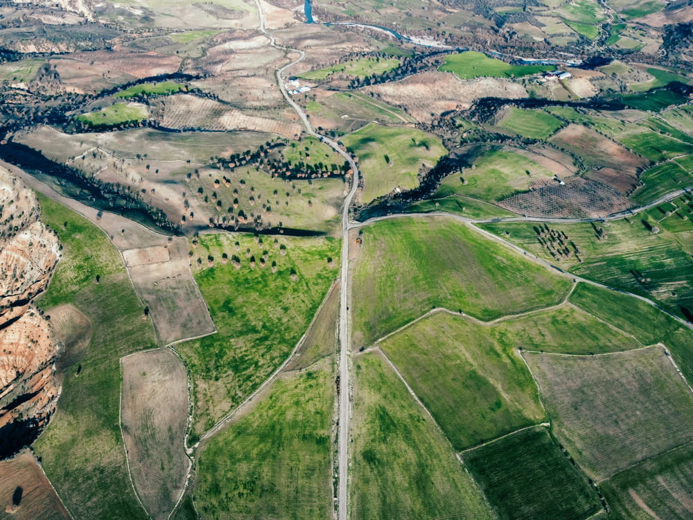 an aerial view of a road winding through a valley