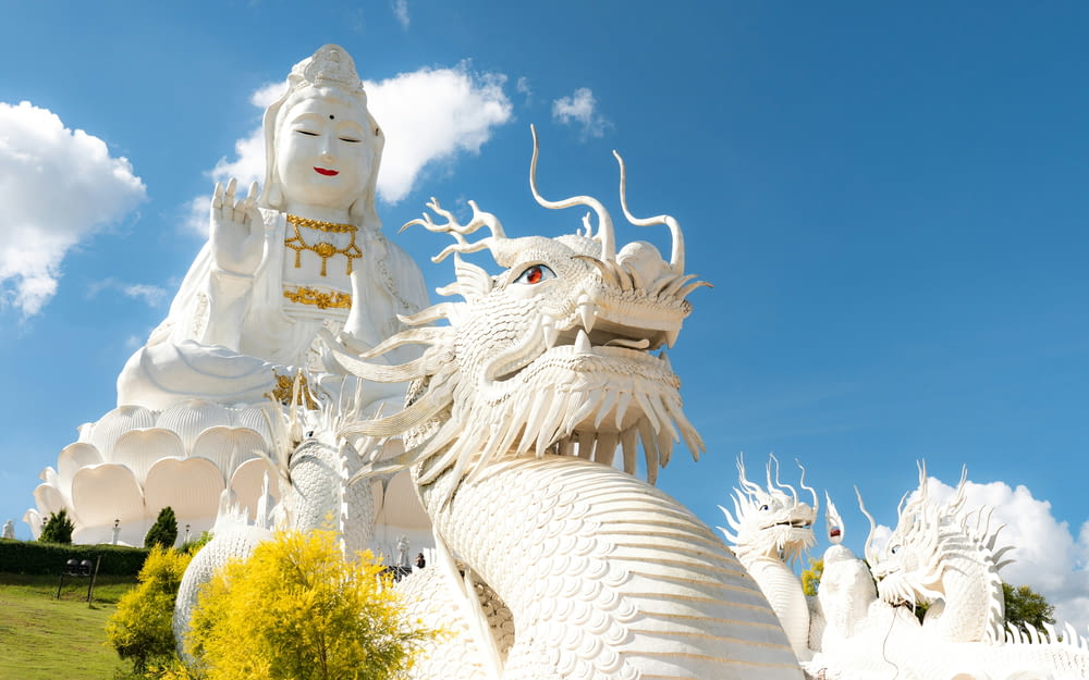 a statue of a white dragon and a white statue of a white dragon
