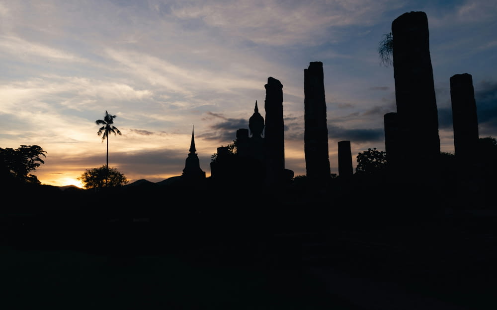 a silhouette of a city with tall buildings