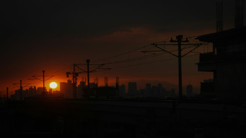 the sun is setting over a city skyline