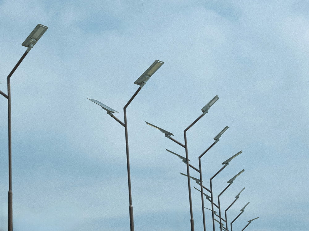 a row of street lights on a cloudy day