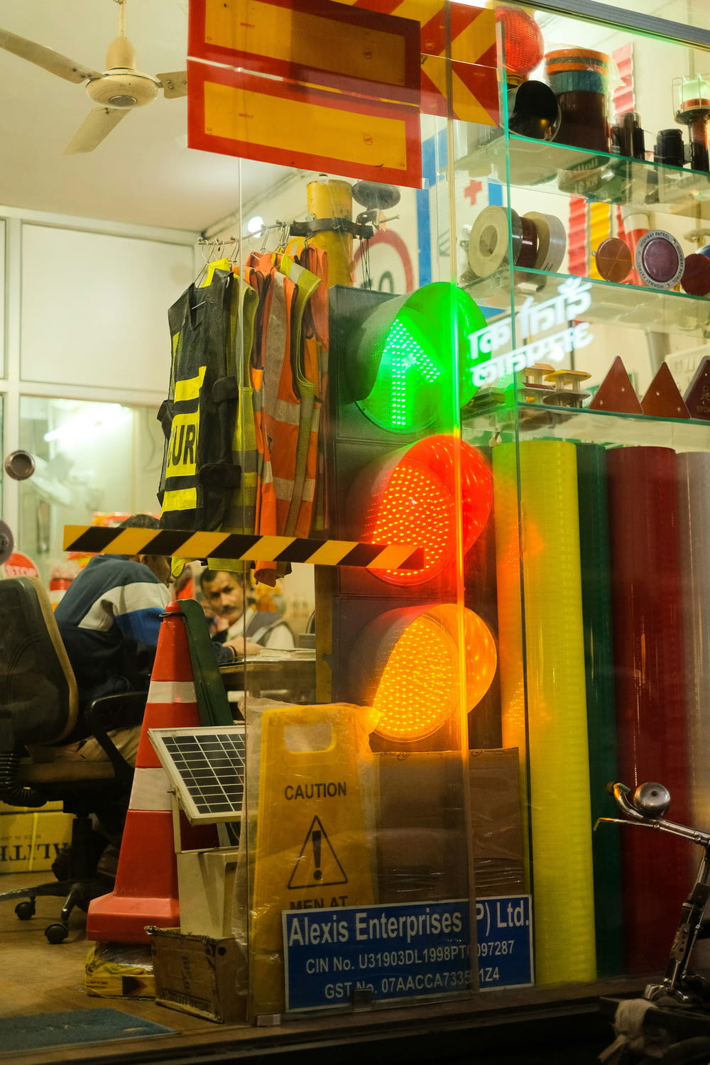 a traffic light sitting in front of a store window