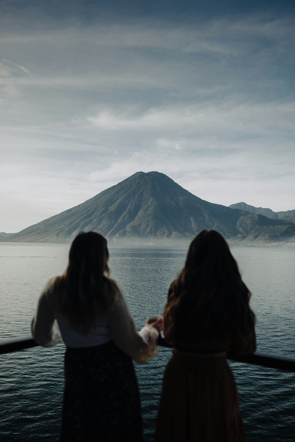 two women looking out over a body of water