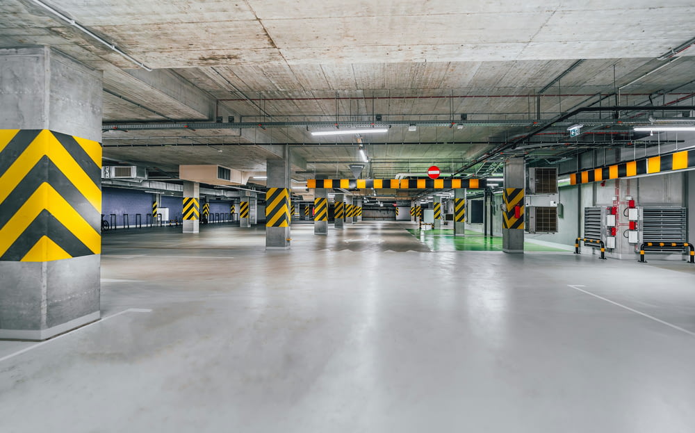 an empty parking garage with yellow and black stripes