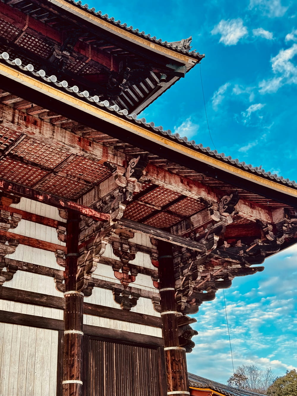 a tall wooden building sitting under a blue sky