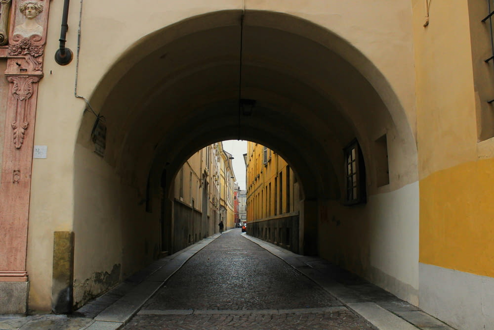 a street with a tunnel between two buildings