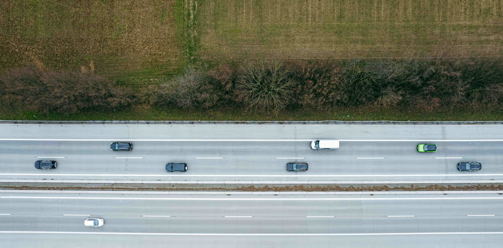an aerial view of a highway with several cars