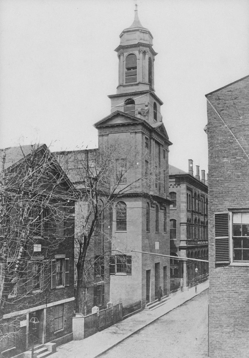 an old black and white photo of a building with a clock tower