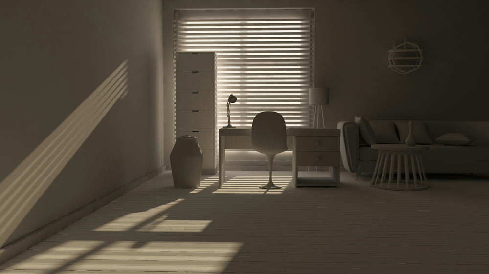 a room with a chair, desk and a window with blinds