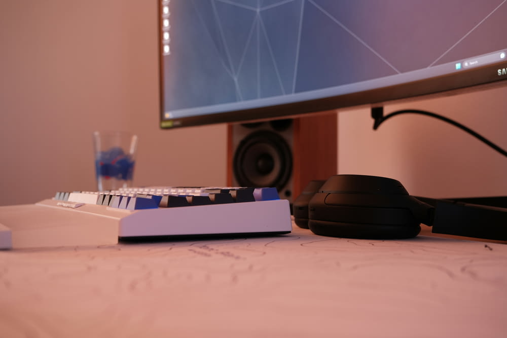 a computer keyboard sitting on top of a desk