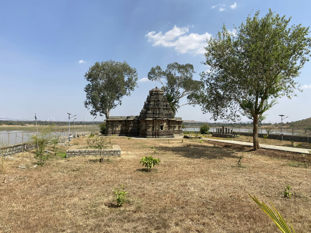 a small temple in the middle of a field