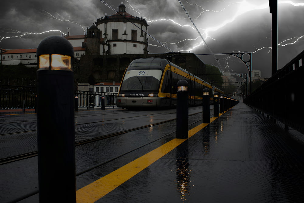 a train on a track with a lot of lightning in the background