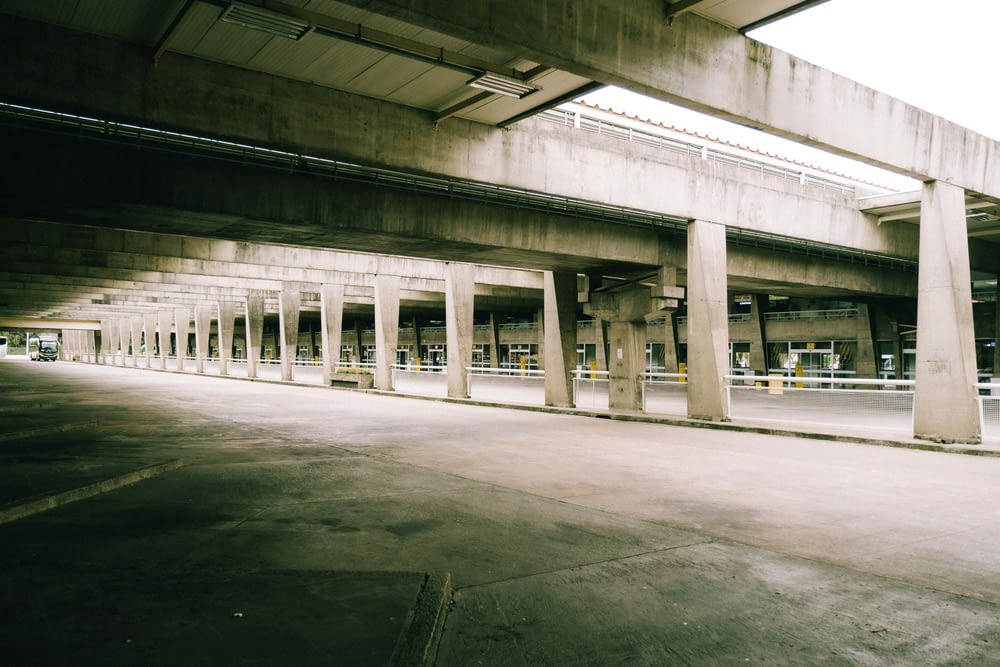 an empty parking garage with columns and concrete walls