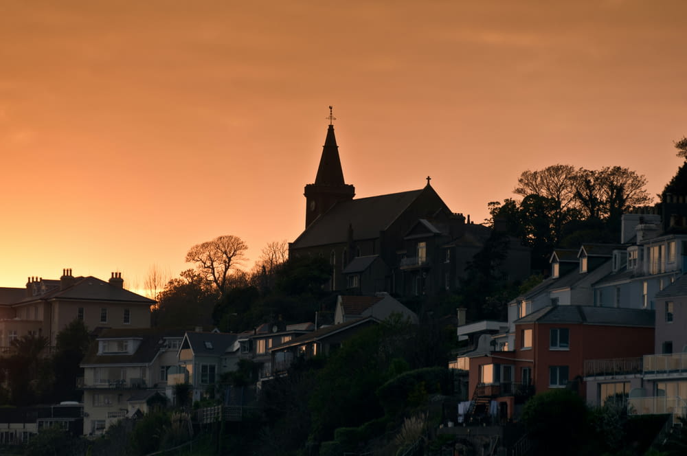 a sunset view of houses on a hillside
