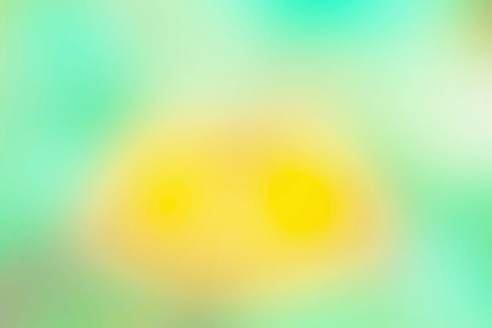 a blurry image of yellow and green circles