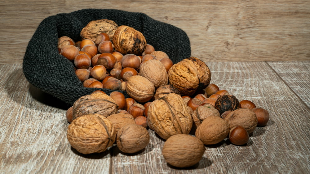 a pile of nuts sitting on top of a wooden table