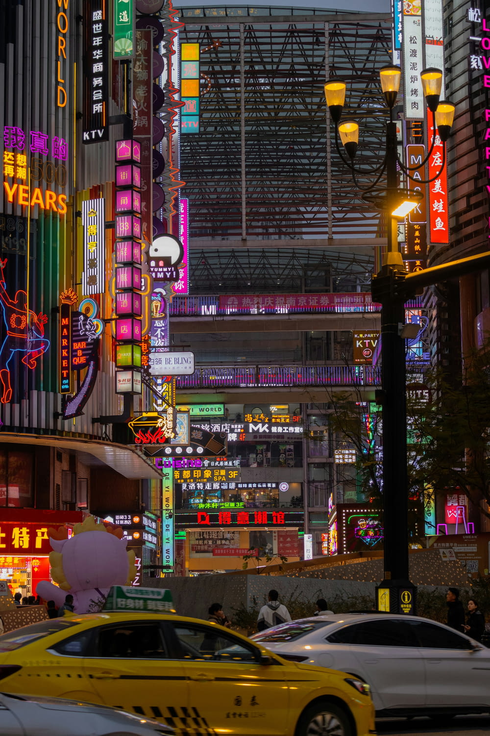 a busy city street filled with lots of neon signs
