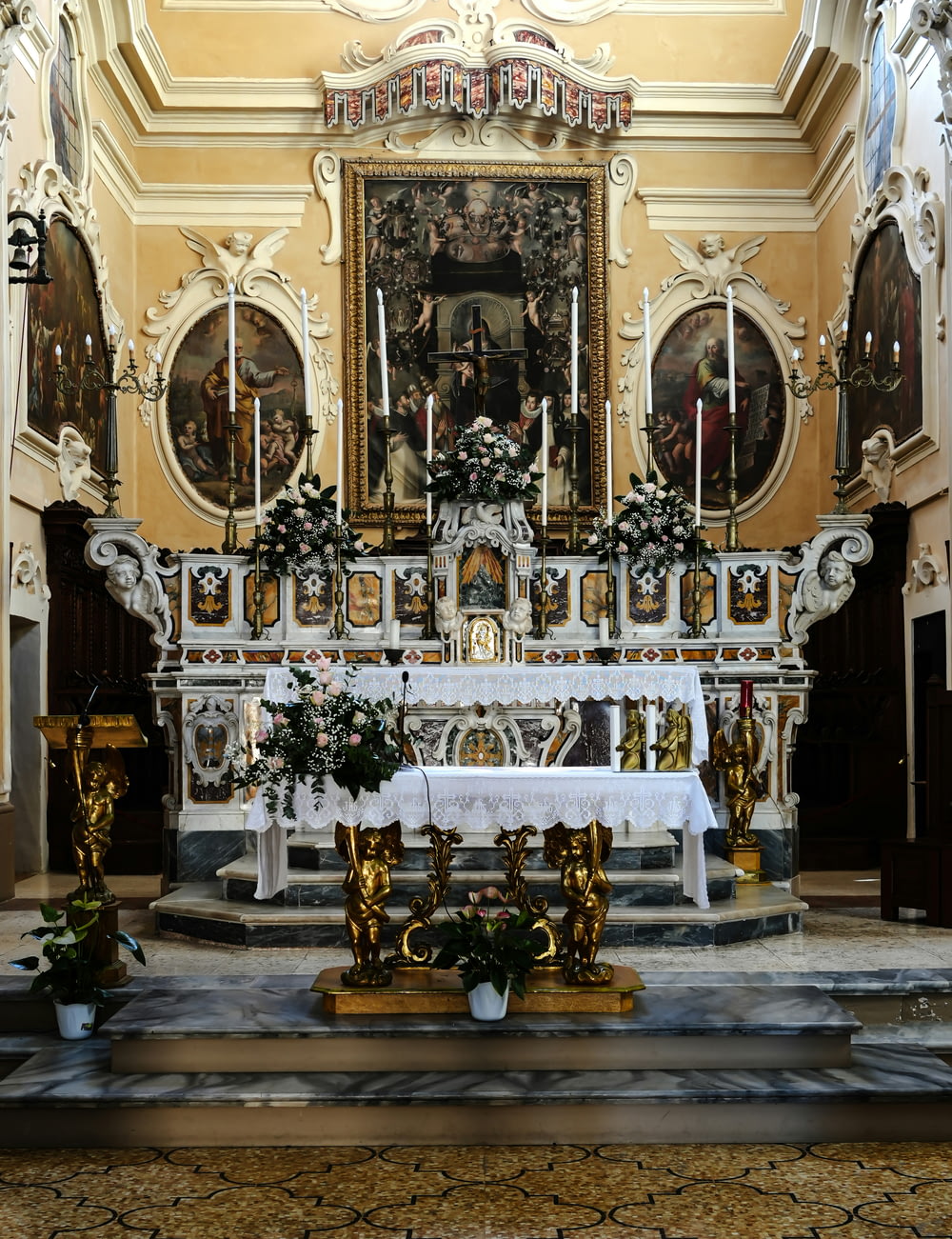 a church altar with a white table cloth on it