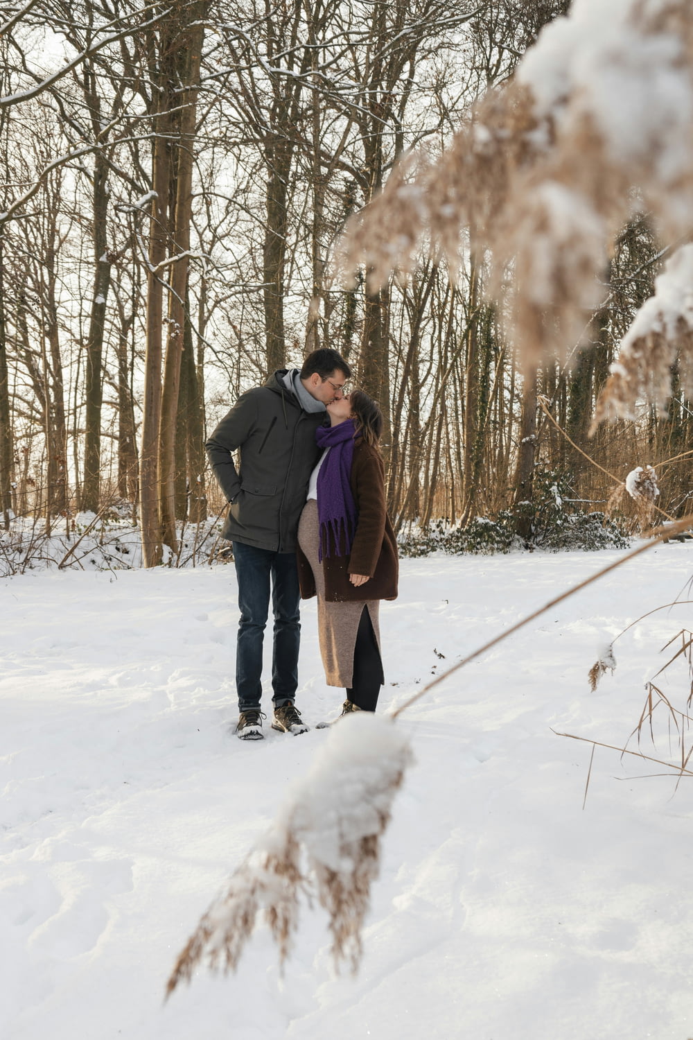 a man and a woman standing in the snow