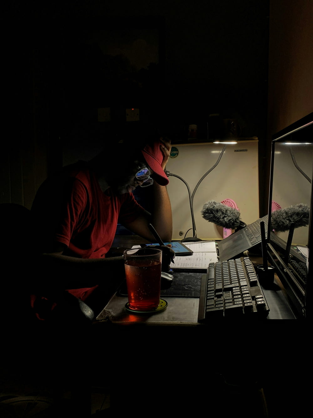 a man sitting in front of a computer in the dark