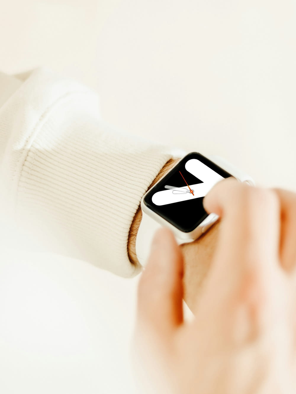 a person holding a smart watch in their hand