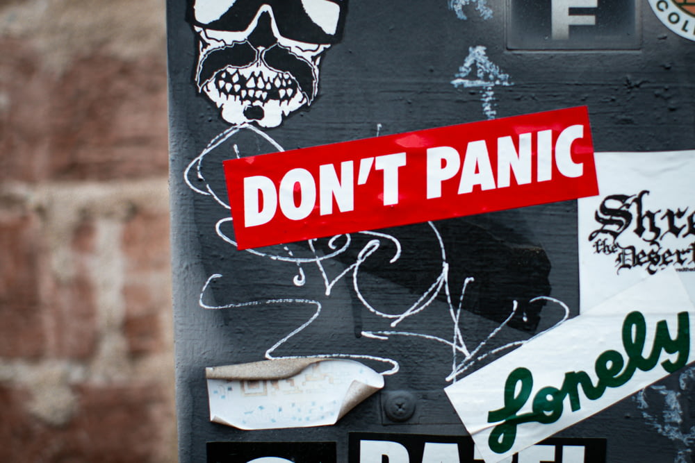 a sign with stickers on it that says don't panic