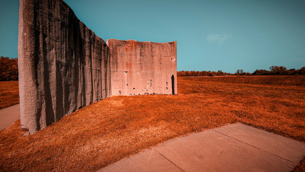 a concrete structure with grass growing out of it