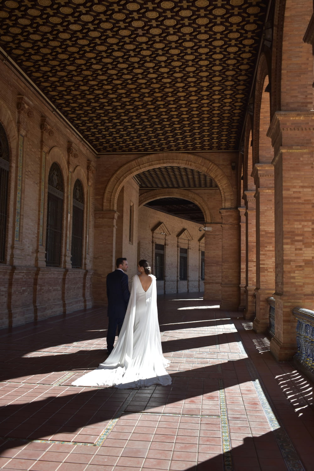 a bride and groom standing in an archway