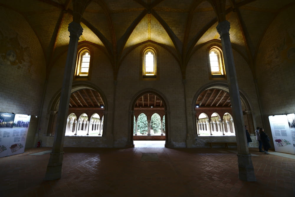 the inside of a building with arches and windows