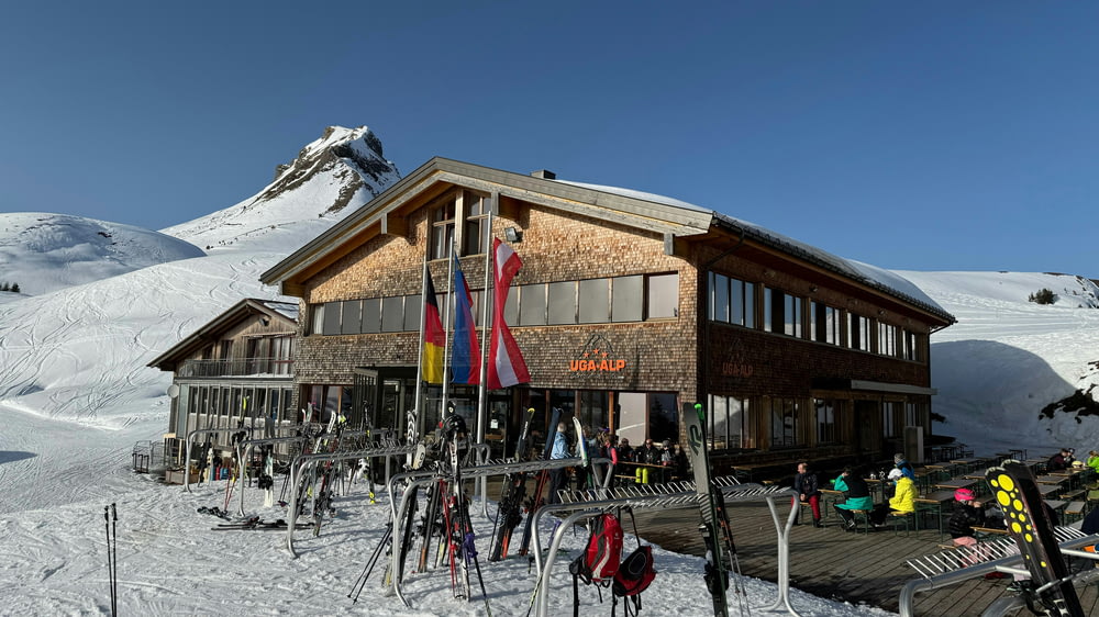 a group of people standing outside of a ski lodge