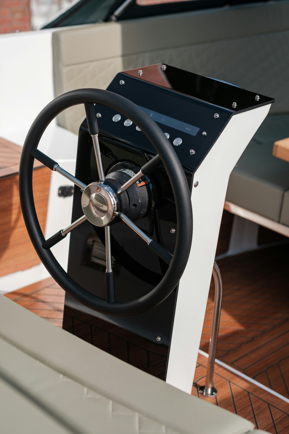 a steering wheel of a boat on a wooden deck