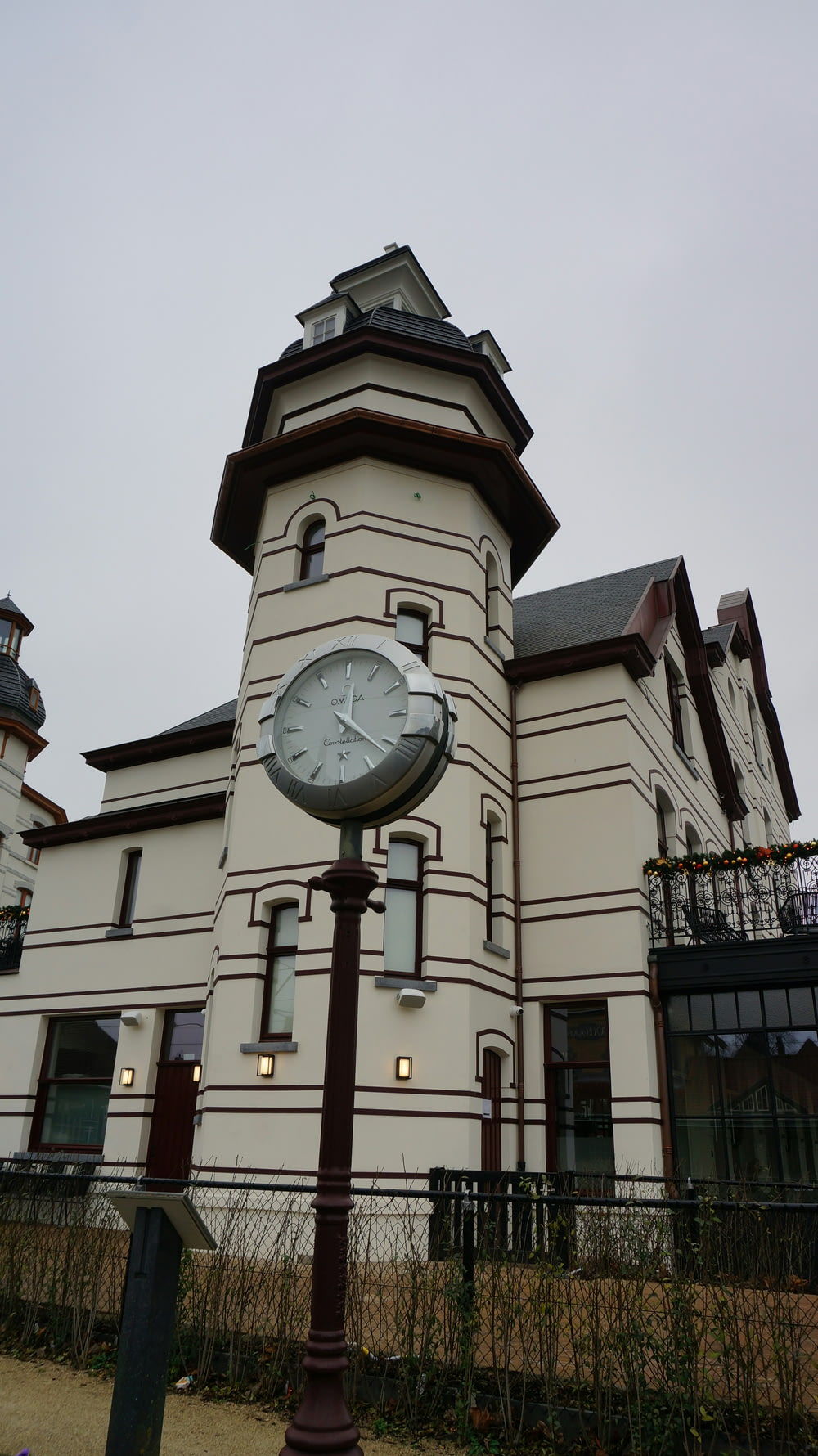 a clock on a pole in front of a building