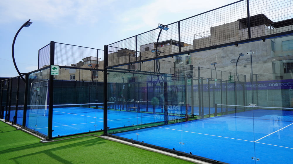 a tennis court with a fence surrounding it