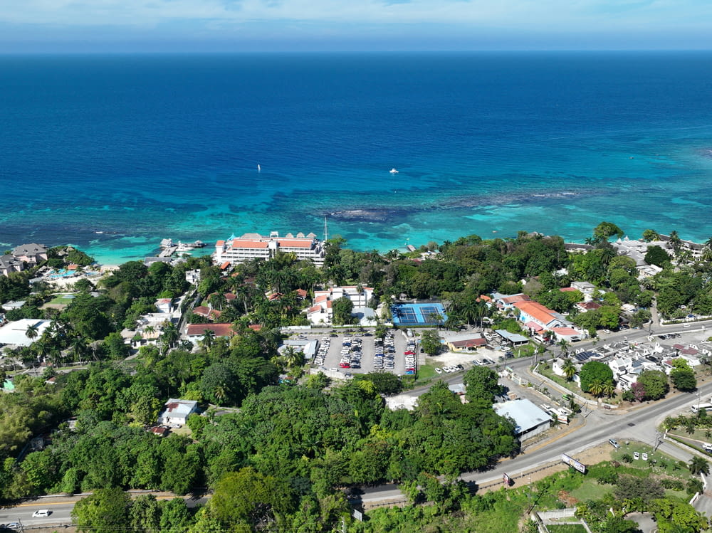 an aerial view of a town and the ocean