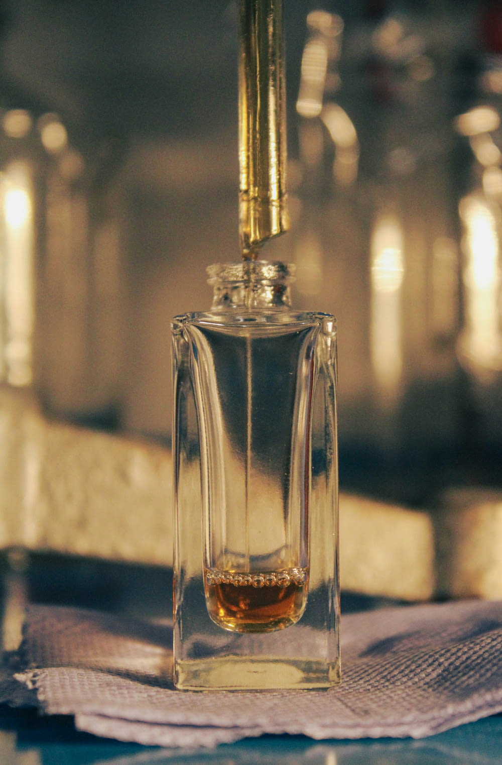 a small bottle of perfume sitting on top of a napkin