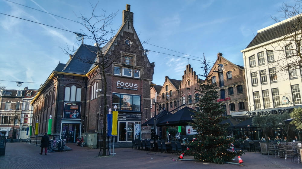 a christmas tree is in the middle of a town square