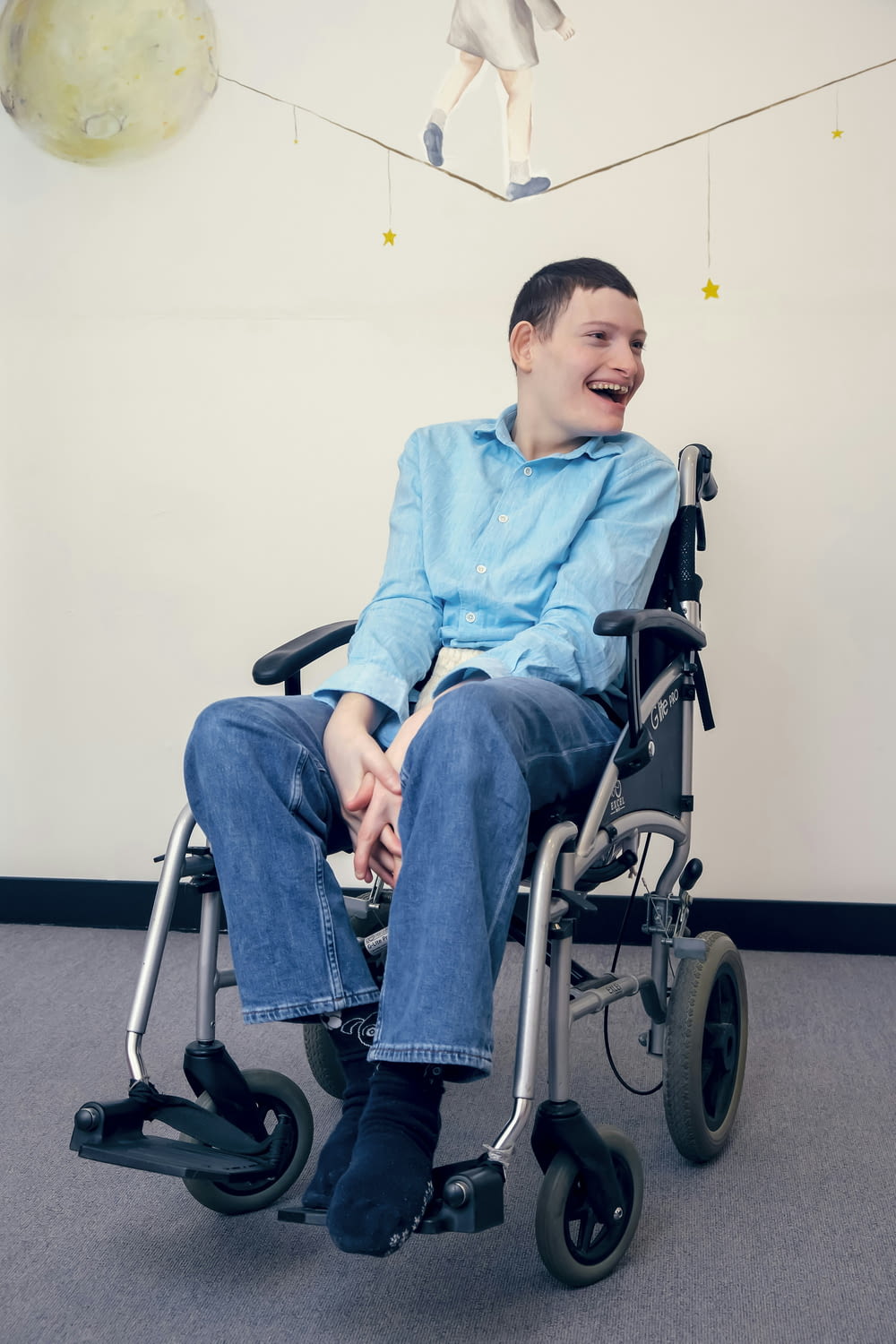 a man sitting in a wheel chair in a room